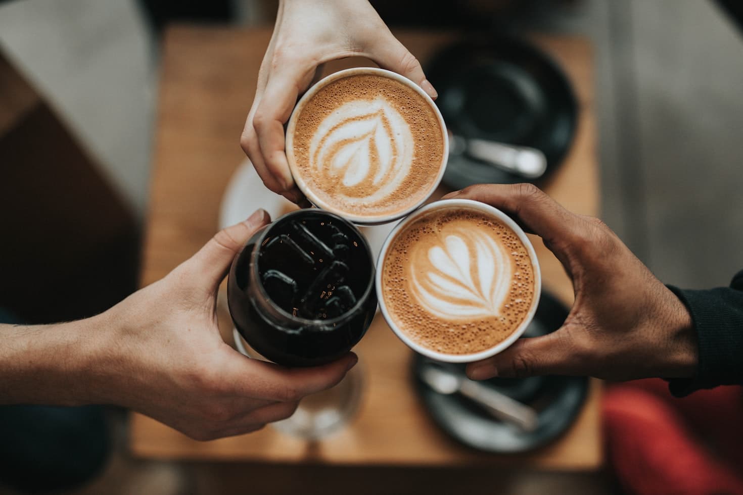 People sharing coffee together around a café table